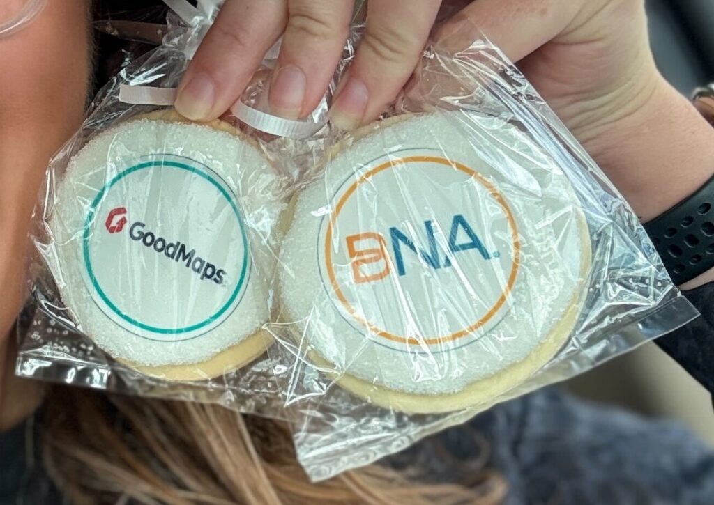 Cookies decorated with icing display the BNA and GoodMaps logos.