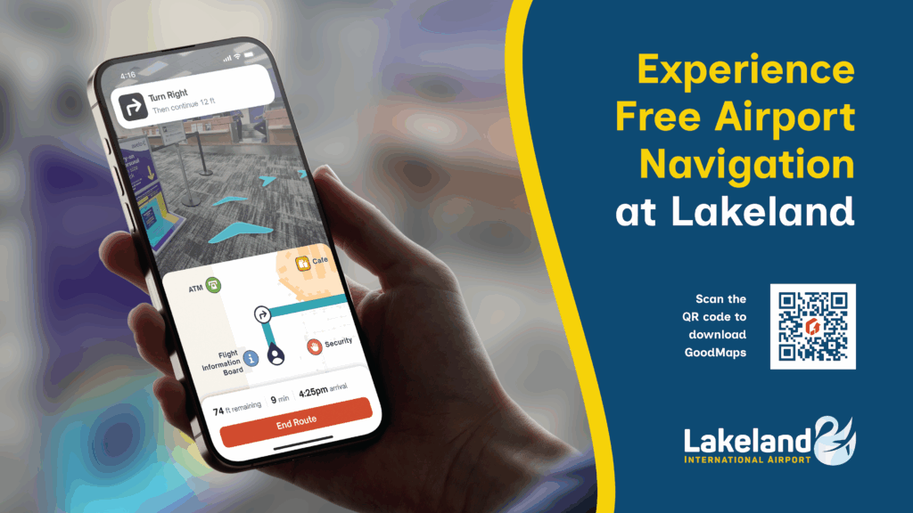 The sign is split in half, with one side depicting the GoodMaps app in usage at LAL and the other half with the text: Experience Free Airport Navigation at Lakeland. Scan the QR code to download GoodMaps.