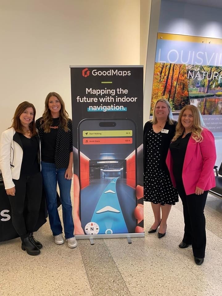Members from each team stand either side of a GoodMaps roll-up banner which states: Mapping the Future with Indoor Navigation.