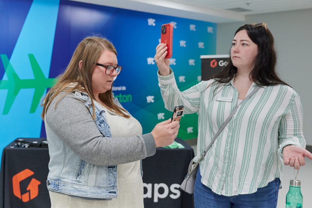 Two members of the YFC team use their smartphones to test the GoodMaps app.