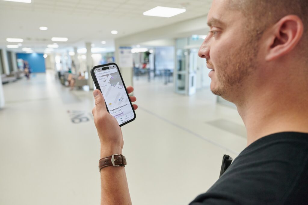 Kevin using the GoodMaps app on his smartphone at YFC airport.